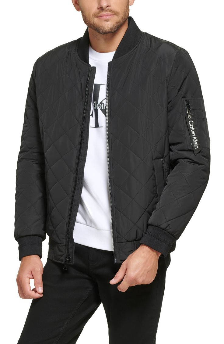 A classic bomber jacket gets updated with a quilted texture for casual yet cool style. Baseball collar Long sleeves 100% polyester Machine wash Imported Model stats: 6'1" height, 32" waist. Model is wearing size M. Casual Quilted Outerwear For Streetwear, Casual Nylon Quilted Jacket With Padded Collar, Black Quilted Jacket With Ribbed Cuffs For Fall, Casual Quilted Puffer Jacket, Casual Black Quilted Outerwear, Casual Quilted Nylon Outerwear, Casual Quilted Jacket With Ribbed Cuffs For Streetwear, Casual Quilted Jacket With Padded Collar For Spring, Casual Black Nylon Quilted Jacket