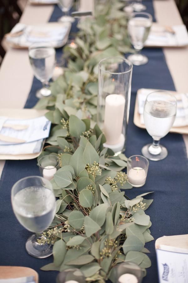 a long table is set with candles and place settings