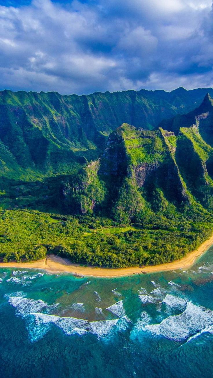 an aerial view of the ocean and mountains