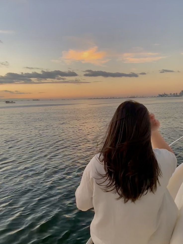 a woman on a boat looking out at the water