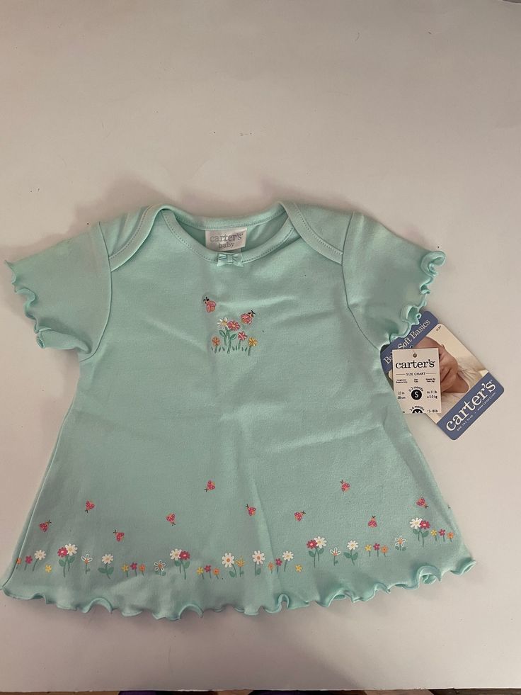 0-3 Month Infant girls top Small 23  inches to 11 lbs. 100 % Cotton Exclusive of decoration. Ruffle sleeves and on the  bottom on shirt.  Round neck, Two bees, Five flowers with two bees on the top part of shirt. Bottom has ruffle with flowers and bees also. Still has the tags. Blue Cotton T-shirt With Ruffles, Fitted T-shirt For Spring, Cute Flutter Sleeve Tops For Spring, Spring Short Sleeve T-shirt With Ruffles, Fitted Cotton Top With Flutter Sleeves, Fitted Cotton Tops With Flutter Sleeve, Spring Crew Neck Tops For Playtime, Short Sleeve Tops For Playtime In Spring, Crew Neck Tops For Playtime In Spring