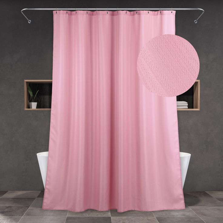 a bathroom with a pink shower curtain next to a white bathtub and window in the background