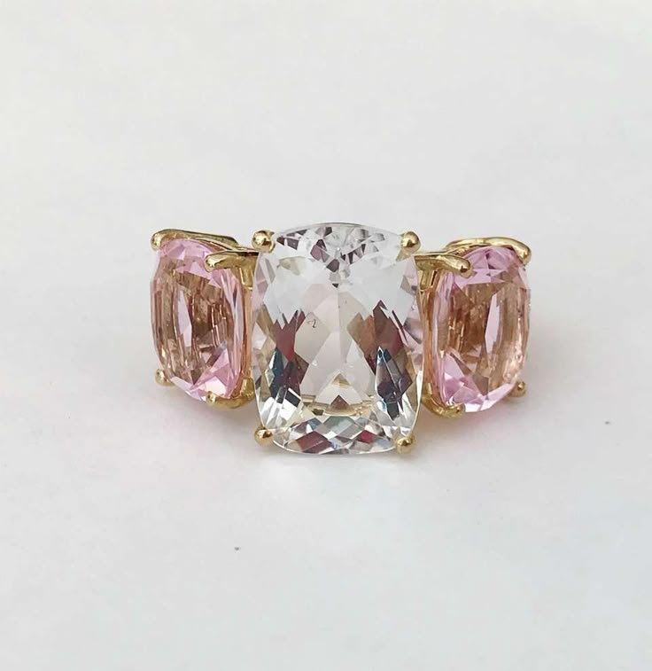 For Sale on 1stdibs - 18kt Rose Gold Three Stone faceted Cushion Ring with center Rock Crystal and two Pale Pink Topaz finished with a tapered split shank. This elegant cocktail Pink Gold Jewelry With Center Stone For Formal Occasions, Formal Pink Gold Jewelry With Center Stone, Formal Pink Gold Rings With Accent Stones, Rose Gold Baguette Cut Jewelry With Center Stone, Elegant Rose Gold Trillion Cut Ring, White Baguette Cut Gemstone Rings, Formal Pink Gold Ring With Center Stone, White Topaz Ring With Brilliant Cut In Luxury Style, White Topaz Ring With Accent Stones For Formal Occasions