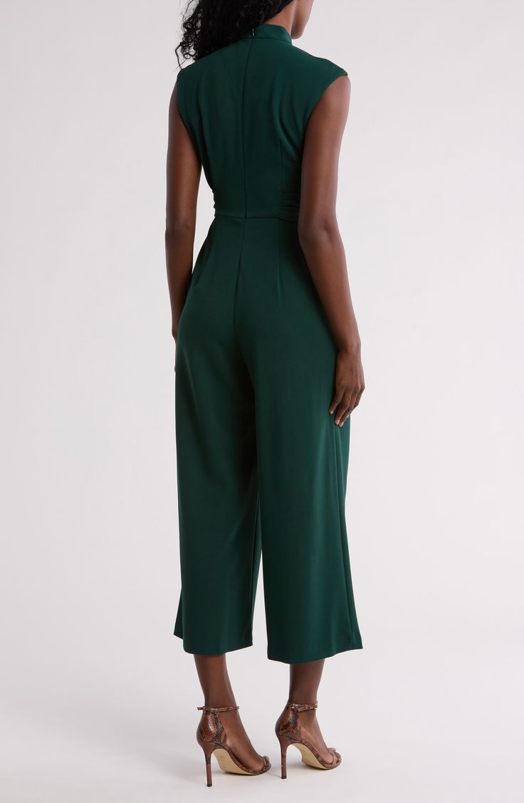 A contrasting buckle defines the waist of this woven jumpsuit that's cut right at your ankle for trend-right charm. 25 1/2" inseam Hidden back-zip closure Mock neck
 Cap sleeves Side-seam pockets Removable waist tie 66% polyester, 30% recycled polyester, 4% spandex Dry clean Imported Fitted Belted Strapless Jumpsuit, Belted Strapless Jumpsuit For Workwear, Fitted Sleeveless Jumpsuit With Belt Loops, Chic Belted Strapless Jumpsuit For Work, Fitted Calvin Klein Jumpsuits And Rompers For Party, Chic Belted Green Jumpsuits And Rompers, Chic Green Belted Jumpsuits And Rompers, Chic Green Belted Jumpsuit, Workwear Jumpsuits And Rompers With Belt Loops