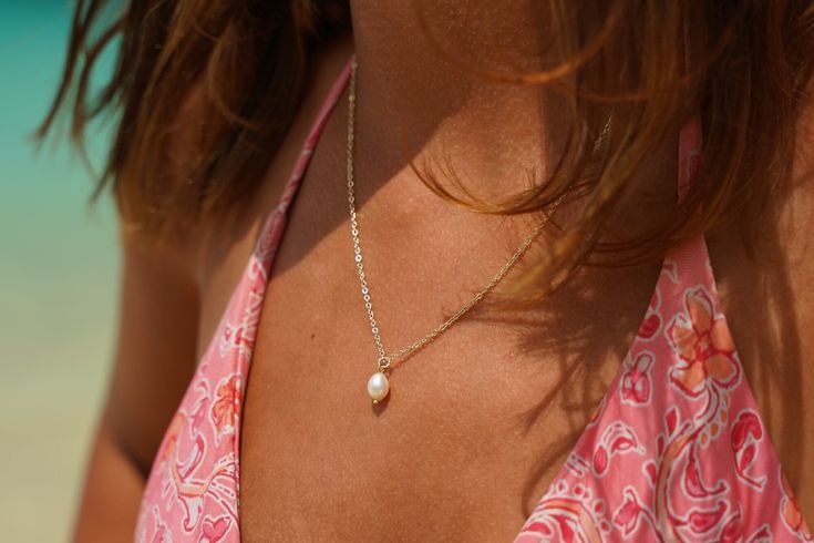 "Minimalist white freshwater pearl summer choker. Dainty pearl drop choker is classy and elegant.Perfect summer accessory for your beach and traveling accessory. This pendant set is perfect for formal events such as wedding and bridal party. The floating pearl can be a great addition to a bridesmaid proposal box.Currently this necklace is available in silver and gold.Each necklace is handmade by a small business in Canada located approximately an hour from Toronto, Ontario. BUY DISCOUNTED BRIDAL BUNDLE  https://www.etsy.com/ca/listing/1231873086/bridesmaid-necklace-bundle-bridesmaid?click_key=187f7ba064cf9d5c503da62a119bb797099a99a2%3A1231873086&click_sum=7f038993&ref=shop_home_recs_17&pro=1&frs=1 Item Specifications ∗Material chain: Gold plated nickel and lead free brass, silver plated co Elegant Pearl Drop Necklace For Summer, Summer Pearl Necklace With Pearl Pendant, Summer Pearl Pendant Jewelry, Elegant Summer Pearl Charm Necklaces, Elegant Summer Pearl Necklace With Pearl Charm, Elegant Summer Pearl Necklace With Charm, Summer Wedding Jewelry With Pearl Charm, Summer Dainty Pearl Chain Jewelry, Summer Wedding Pearl Charm Jewelry