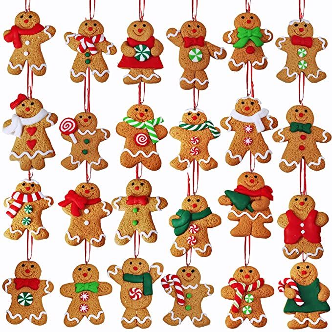 a group of gingerbread cookies hanging from strings