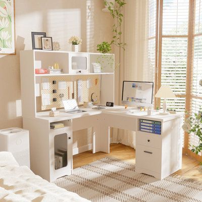 a bedroom with a bed, desk and shelves in it's corner area next to a window