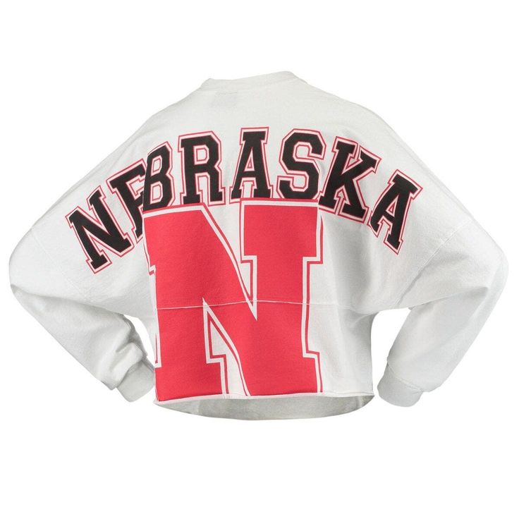 Whether you're a current student, alumni or just a superfan, every member of the Nebraska Huskers franchise needs a solid collection of gear. This season, spruce up your look with this chic Raw Hem Cropped Spirit Jersey T-shirt! The fierce Nebraska Huskers graphics and super-soft blend make this fun top a must-have addition to your closet! Brand: Spirit Jersey Crew neck Long sleeve Machine wash, tumble dry low Made in the USA Material: 100% Cotton Officially licensed Raw hem Rib-knit collar and Oversized Graphic Tee For College, Collegiate Tops With Graphic Print And Relaxed Fit, College Graphic Tee With Crew Neck, Collegiate Graphic Print Relaxed Fit Tops, Collegiate Letter Print Tops For Fall, Collegiate Relaxed Fit Top With Text Print, Varsity Long Sleeve Top With Logo Print, Varsity Tops With Text Print, Varsity Style Tops With Text Print And Relaxed Fit