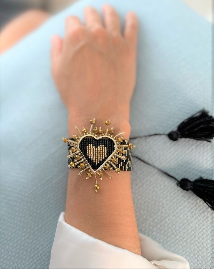 Black and Gold Heart Handmade bracelet, this is a unique artisan piece handcrafted in Colombia, perfect gift for her Boho chic Adjustable bracelet designed with a slider that glides to fit you perfectly. Beautiful and unique piece handmade in Colombia. Total bracelet circumference adjustable up to 9.5 inches Width: 1 inch More colors in our Etsy shop: https://www.etsy.com/shop/PuroCorazonDesigns Handmade Heart-shaped Jewelry For Festivals, Bohemian Beaded Bracelets For Gifts, Bohemian Embroidered Adjustable Bracelets, Bohemian Adjustable Embroidered Bracelets, Artisan Resizable Jewelry As Gift, Adjustable Woven Beaded Bracelets As Gift, Artisan Resizable Jewelry Gift, Adjustable Woven Beaded Bracelets For Gifts, Elegant Handmade Friendship Bracelets For Festivals