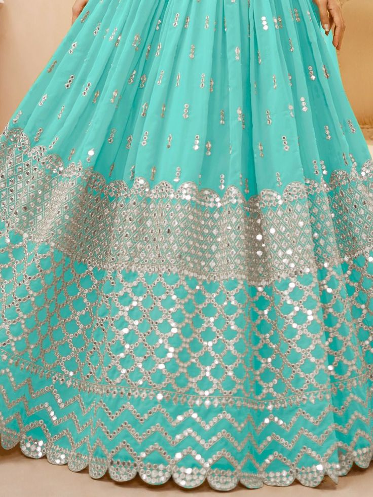 Perfectly pretty and eye-catchy, the spectacular sky blue sequins georgette sangeet wear lehenga choli is a must-have for any special occasion. This stunning ensemble includes sky blue sequins and zari work georgette lehenga, a matching blouse, and a sky blue sequins and zari lace net dupatta.
The lehenga is semi-stitched and can be customized up to 42 inches, while the blouse comes with unstitched material for a perfect fit. The intricate sequins and zari work on both the lehenga and blouse add Blue Georgette Sharara For Reception, Blue Sequined Party Wear Sets, Blue Embellished Georgette Anarkali Set, Blue Embellished Sets In Georgette, Blue Embellished Georgette Lehenga, Blue Embellished Georgette Sets, Blue Embellished Salwar Kameez For Navratri, Blue Saree Sets With Sequins, Embellished Blue Sharara For Eid