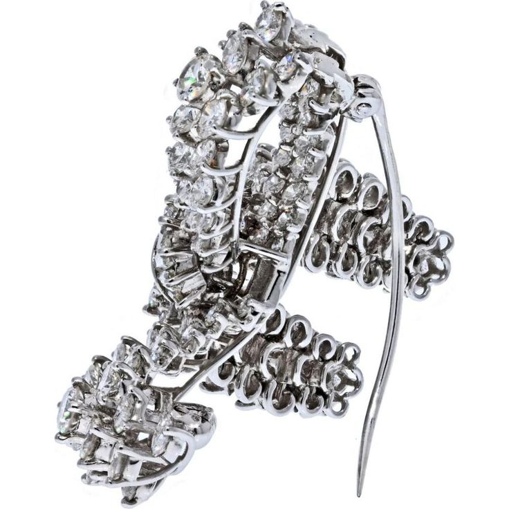 Bask in the glow of luxury, where timeless elegance meets modern aesthetics in the exquisite Platinum 10 Carat Diamond Bow Brooch. This captivating piece features a lustrous diamond bow design, adorned with round-cut diamonds and baguette cuts that showcase a dazzling play of light. With a remarkable estimated carat weight of 10.00cts, this brooch exudes opulence and sophistication.Crafted in luxurious platinum, this brooch is a true testament to fine craftsmanship and enduring beauty. The F-G color and VS1-VS2 clarity of the diamonds ensure a brilliant sparkle that catches every eye. Measuring about 1.5 inches wide, this stunning brooch is a versatile accessory that adds a touch of glamour to any ensemble.Whether worn on a lapel, dress, or scarf, this brooch is a statement of refined eleg Formal Diamond White Brilliant Cut Brooch, Formal Single Cut Diamond Brooch, Luxury Diamond White Brooches For Formal Events, Luxury Diamond White Brooches For Formal Occasions, Formal White Gold Brooches With Diamond Accents, Formal White Gold Platinum Brooches, Luxury Diamond White Brooch With Brilliant Cut, Diamond White Brooch With Diamond Accents, White Gold Diamond Brooch With Brilliant Cut