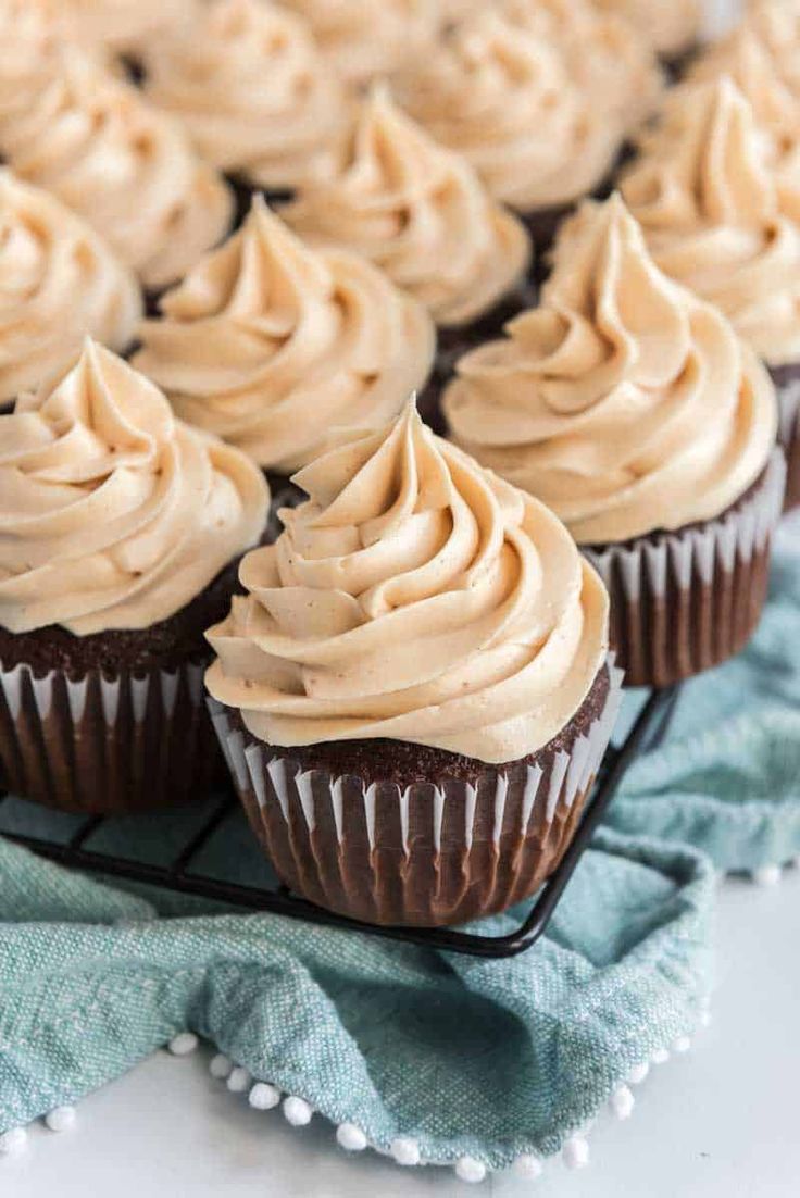 chocolate cupcakes with frosting on a cooling rack