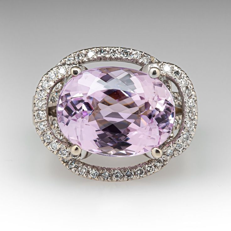 This kunzite ring is centered with one (1) oval mixed cut natural kunzite set into a four-prong setting. The ring is also accented with eighty-four (84), prong set, round brilliant cut diamonds. The ring measures 18.0mm at the top, rises 11.9mm above the finger, tapering to 3.5mm wide and 1.3mm thick at the base of the shank. It is currently a size 8.75. Exquisite Pink Sapphire Rings For Formal Occasions, Exquisite Pink Sapphire Rings For Formal Events, Formal Morganite Gemstone Rings, Luxury Pink Oval Topaz Ring, Pink Gemstones For Formal Fine Jewelry, Classic Pink Gemstones For Formal Occasions, Pink Gemstones For Formal Occasions, Oval Morganite Ring For Formal Occasions, Elegant Round Pink Sapphire Gemstones