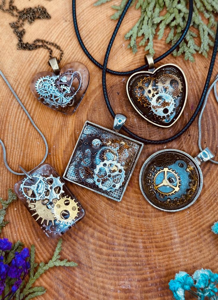 Discover the enchanting allure of vintage industrial art with our exclusive collection of Handmade Steampunk Resin Pendant Necklaces. Each pendant in this series is a unique masterpiece, meticulously crafted to showcase intricate gear and clockwork designs encased in high-quality resin. Perfect for steampunk enthusiasts, gearheads, and lovers of unique jewelry, these pendants make a striking addition to any collection. *Features **Handcrafted Elegance Every pendant is lovingly handmade, ensuring Vintage Silver Electroformed Necklaces, Vintage Upcycled Jewelry As Gift, Unique Upcycled Jewelry As A Gift, Unique Upcycled Jewelry Gift, Unique Upcycled Jewelry For Gifts, Polymer Clay Steampunk, Steampunk Aesthetic, Steampunk Pendant, Resin Pendant Necklace