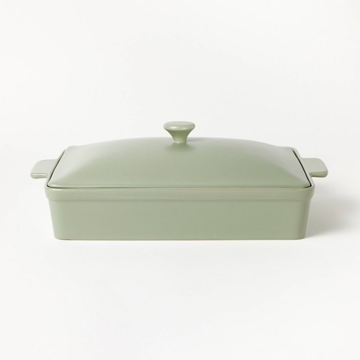 a green casserole dish on a white background