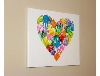 a heart made out of colorful handprints on a white wall