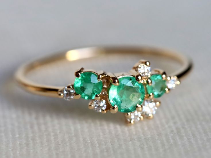 9k/14k solid gold emerald ring, Diamond cluster ring, emerald cluster ring, gold cluster ring, diamond emerald ring, emerald engagement ring Same design can be made also with other custom gemstones per request. Product details: - Solid gold - Diamond - 1.5mm and 2, emerald - 2.5, 3 and 4mm - 1.1mm band - Made to order - 8 to 10 business days. Ring size - US 3 to US 9 (for smaller or larger ring size, please contact) Please select your size at the drop down menu. Service Available - Customization Diamond Emerald Ring, Ring Cluster, Green Emerald Ring, Emerald Ring Gold, Cluster Engagement Ring, Ring Emerald, Emerald Engagement, Large Ring, Emerald Engagement Ring