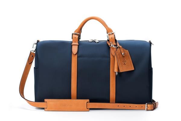 The Monaco Weekender - Navy and Tan Luxury Luggage With Adjustable Strap For Trip, Luxury Travel Duffle Bag With Adjustable Strap, Luxury Luggage With Adjustable Strap For Weekend Trips, Classic Tote Luggage For Travel, Classic Travel Tote Luggage, Classic Luggage With Sleeve For Travel, Classic Everyday Travel Accessories With Leather Trim, Rectangular Weekender Bag With Luggage Sleeve, Classic Duffle Bag With Adjustable Strap For Weekend Trips