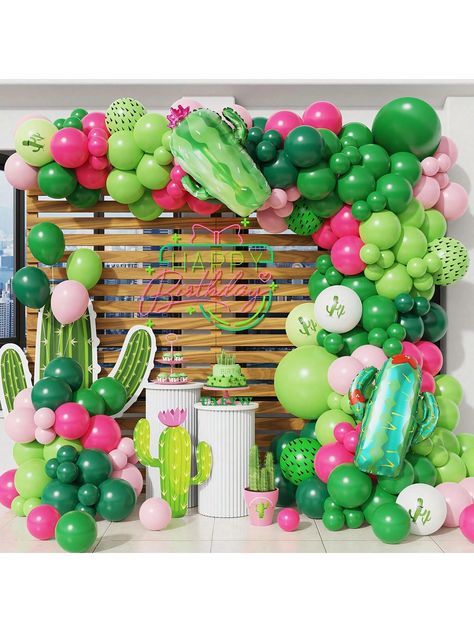 a bunch of balloons and decorations on a table in front of a window with a cactus theme