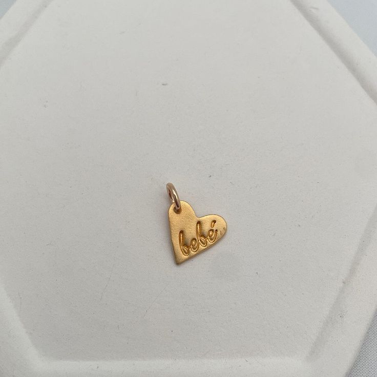 A sweet little accent piece, a perfect addition to any necklace. Our Bebe Heart Charm is available in 18kt vermeil and measures approx. 1/2 inch in diameter.