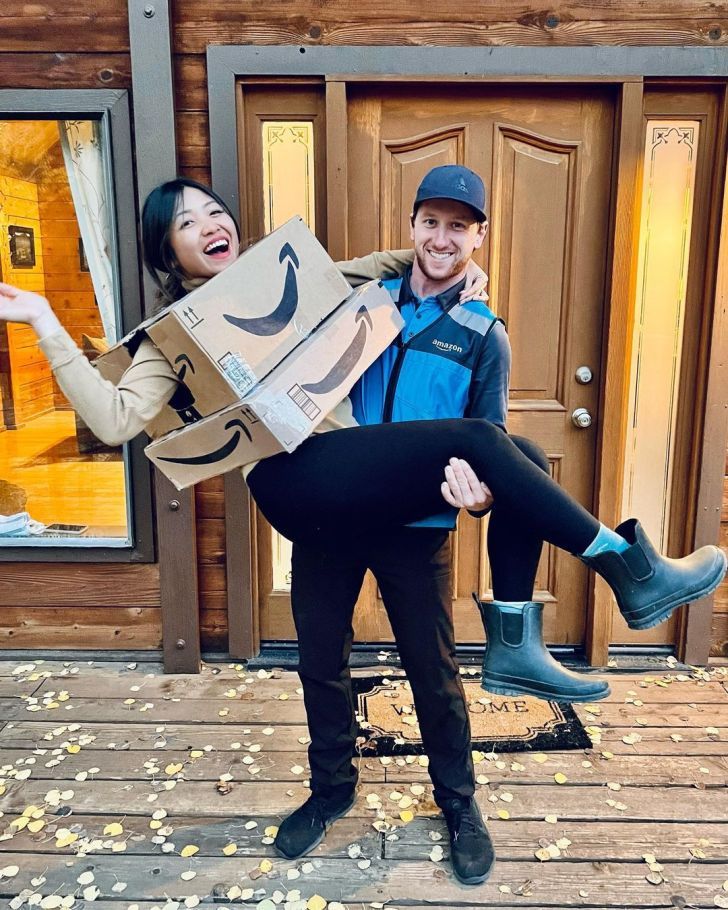 a man and woman are posing with boxes on their heads