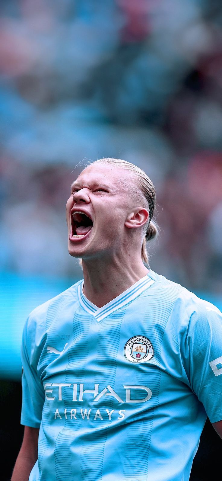 a soccer player with his mouth open in celebration