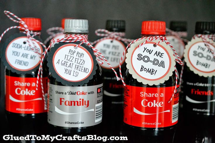 six bottles of soda with labels on them sitting next to each other in front of a black background