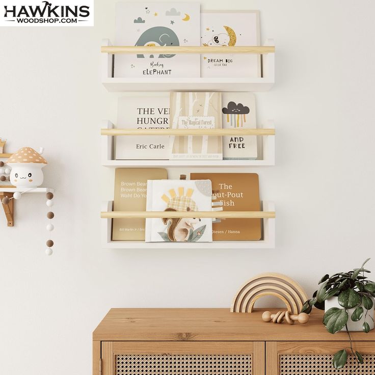 a shelf with books on it next to a potted plant and other items in front of a white wall