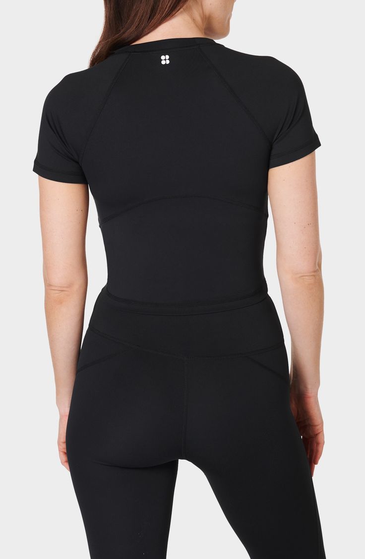 Work out or chill out in this stretchy cropped T-shirt framed by sporty raglan sleeves. 17 1/2" length (size Medium) Crewneck Short sleeves 80% recycled polyester, 20% elastane Machine wash, dry flat Imported Fitted Black Athleisure T-shirt, Black Go-dry Top For Yoga, Black Go-dry Tops For Yoga, Black Athleisure Cropped T-shirt For Workout, Athleisure Stretch Cropped T-shirt With Short Sleeves, Sporty Black Yoga Tops, Go-dry Cropped Sports Top, Functional Sports Crop Top With Crew Neck, Sporty Black Crop Top T-shirt