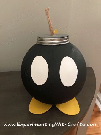 a black and white penguin jar with a straw sticking out of it