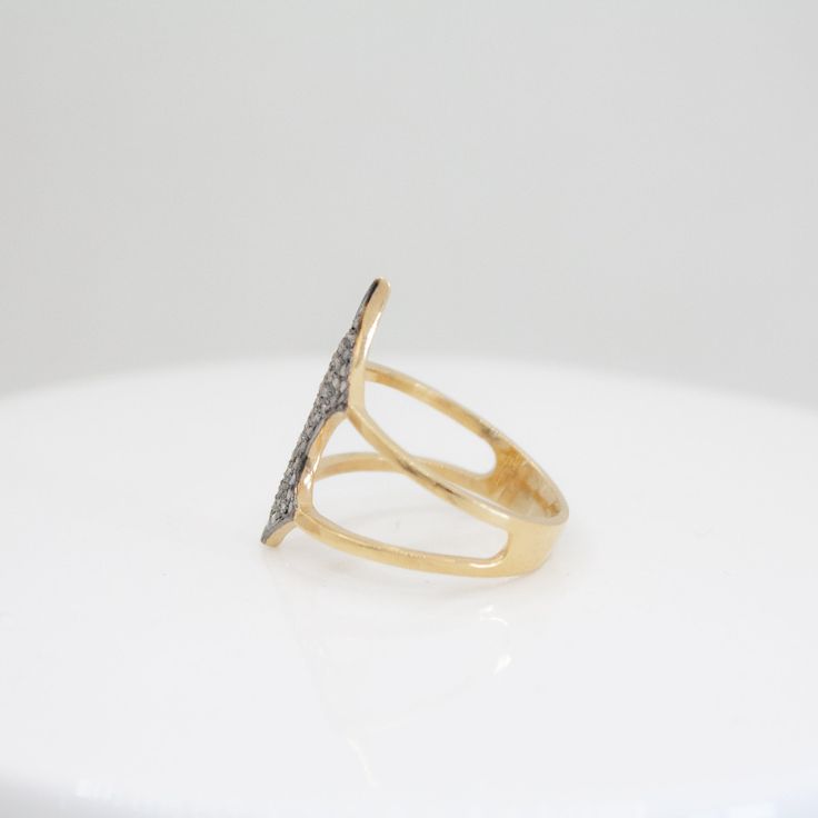 Experience the epitome of luxury and sophistication with our 14k Gold Vermeil .925 Sterling Silver Valyrian Shield Ring. Meticulously handcrafted to perfection, this exquisite piece features a pavé setting of natural, ethically sourced diamonds from India. The pointed shield design, combined with the elegant pavé setting, creates a timeless and refined look, perfect for elevating any ensemble. SPECIFICATIONS: Gross Weight: 3.300 grams Diamond Weight: 0.75 carats INGREDIENTS: Gemstone: Natural Di Dazzling Sapphire Ring With Pave Diamond Setting, Fine Jewelry Diamond Crystal Ring With Single Cut Diamonds, Dazzling 14k Gold Cluster Ring With Pave Setting, Elegant 14k Gold Cluster Ring With Pave Setting, Fine Jewelry Sapphire Ring With Pave Setting, Fine Jewelry Promise Ring With Pave Setting, Gold Open Band Jewelry With Pave Setting, Exquisite 14k Gold Diamond Ring With Pave Setting, Dazzling Open Ring With Pave Setting