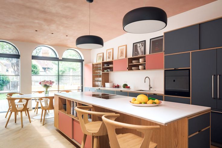 a large kitchen with an island and lots of counter space in front of the windows