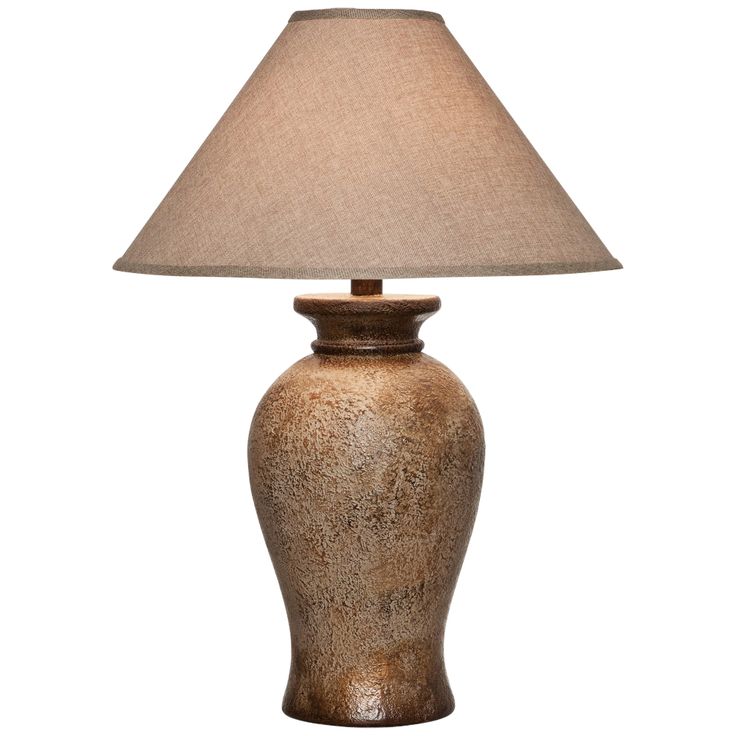 a table lamp with a beige shade on it's base and a white background