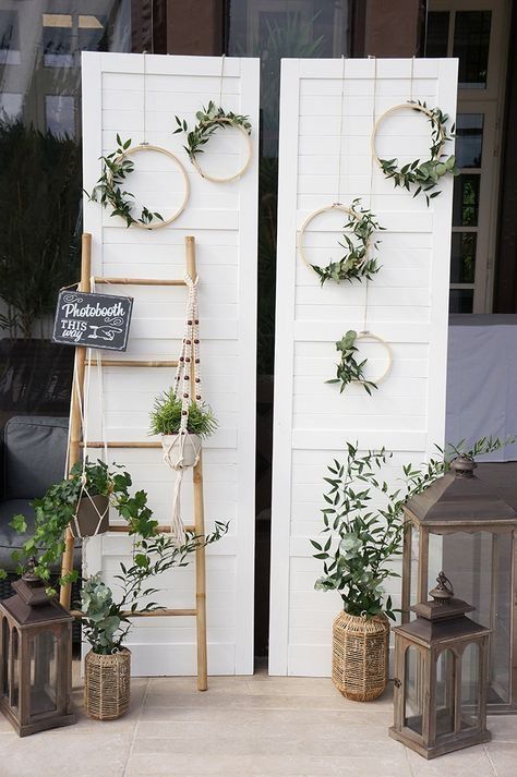 two wooden ladders with plants on them next to a white door and window display