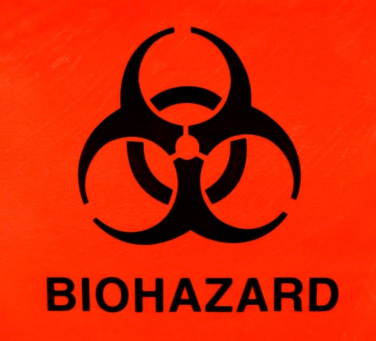 a black and red biohazard symbol on an orange background