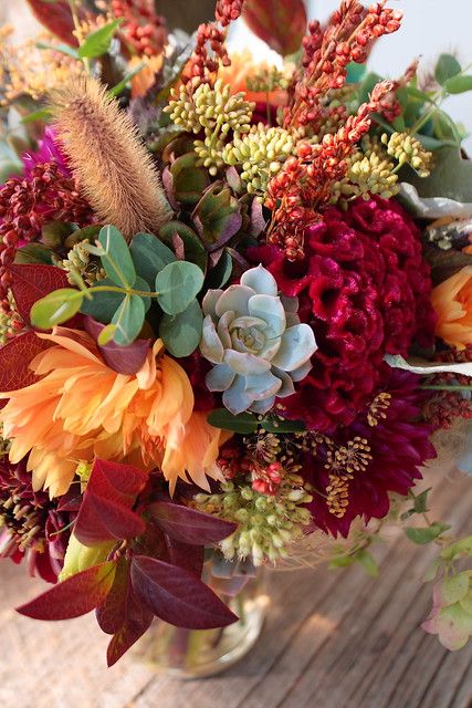 a vase filled with lots of different types of flowers