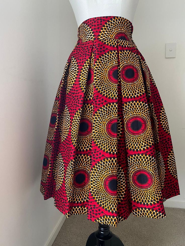 African print box pleated skirt with two sides pockets. Skirt length 28inches .100% cotton. high quality Ankara , Katanga, Kitenge, Lapa. Thank you for stopping by :) Pease select your size from the drop down arrow . We use US sizing. Please choose your choice of fabric from the fabric options. Select the corresponding number of your choice of fabric.  You could send us your measurements if you wish to. Measurements required for this item are: -Waist(smallest part) -Hip -Skirt length. Please do not hesitate to message us if you need any assistance * You can have your skirt shorter or longer upto 32inches at no extra cost. please let us know the length you'd like. Would you like to order this item for a group? We've got you covered. Please place your bulk orders. Should you need any clarity Ankara Skirt Styles High Waist Kitenge, African Attire Skirts High Waist, Ankara Skirt Styles High Waist, Ankara Pleated Skirt, Kitenge Skirts, African Skirts High Waist, Ankara Skirt Styles, African Maxi Skirt, African Skirt