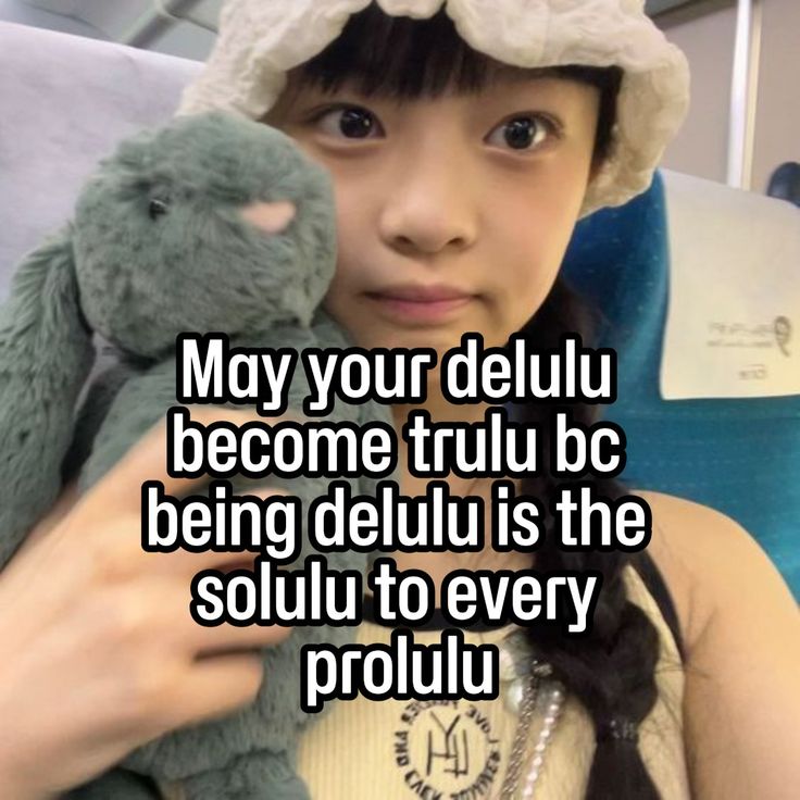 a woman holding a stuffed animal with the caption, may your delu become truly bc being delu is the solution to every prolu