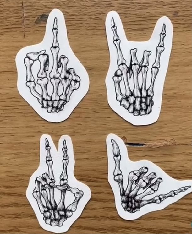 four stickers with different images of hands and bones on them, all showing the same size