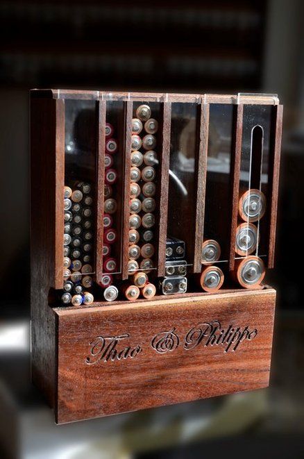 a wooden box filled with lots of different types of buttons on top of a table