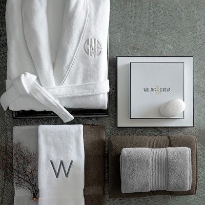 towels and personal items are laid out on the floor, including a bathrobe