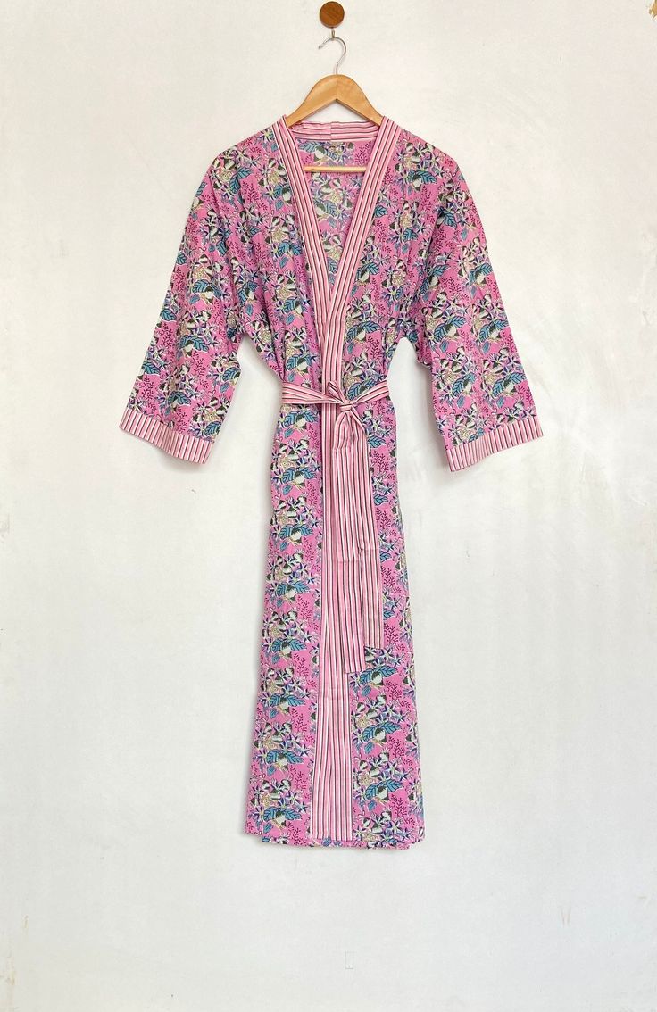 "Cotton kimono robes are perfect for lounging around the home or spa. Use our block print robe as a cover up on the beach or after a dip in the pool. Add a luxe, boho feel to your bridal shower. Versatile, soft and luxurious and best for summer, our 100% cotton kimono robes are printed with azo-free dyes. The block print floral robe features 3/4th sleeves, a waist tie and two front pocket.  Measurements Approx : *Length: 30\" 40\"  50\" Inches *Bust Around Size: 54\" Inches *Shoulder: 8\" Inches *Sleeve Length: 15\" Inches *Sleeve hole: 9\" Inches *2 Side Pockets For best results hand wash and line dry when possible. Machine wash cold, tumble dry low and warm iron. Main Color: - Pink Secondary Color :- Multi Note: The color and brightness of actual product may vary due to digital photograp Spring Kimono With Relaxed Fit, Summer Sleepwear Kimono With Prints, Summer Home Sleepwear With Kimono Sleeves, Summer Sleepwear With Kimono Sleeves For Home, Bohemian Pink Sleepwear For Loungewear, Pink Bohemian Sleepwear For Loungewear, Spring Cotton Kimono For Lounging, Cotton Kimono For Spring Lounging, Pink Kimono For Home Use In Spring