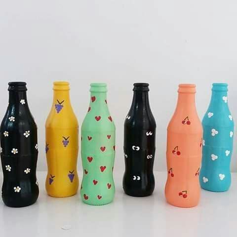 there are many different colored bottles lined up in the same row and one is empty