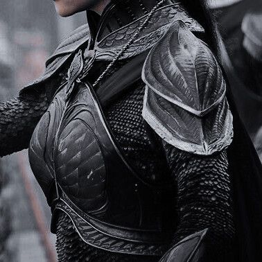 a woman dressed as the dark knight is standing in front of some other people wearing armor