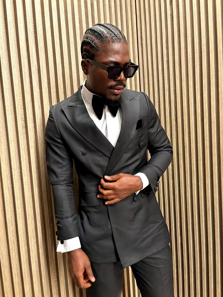 Introducing our custom-tailored, sleek black tuxedo suit, exclusively designed to turn heads at any formal event. Crafted with precision and luxury in mind, this suit blends timeless elegance with modern sophistication. Its clean lines and perfect fit make it an essential piece for the fashion-forward gentleman. Please note that this suit is strictly custom-made, shipping directly from Ghana. To ensure you receive the perfect fit, accurate measurements are required from the customer before we proceed with tailoring. Make this suit uniquely yours by providing your measurements, and let us create a masterpiece tailored to your body. Black Double Breasted Suit For Party, Black Double Breasted Suit For Party With Suit Collar, Black Double-breasted Suit With Suit Collar For Party, Fitted Long Sleeve Double Breasted Suit For Parties, Classic Black Pantsuit For Semi-formal Occasions, Fitted Long Sleeve Pantsuit With Pressed Crease, Fitted Pantsuit With Pressed Crease And Long Sleeves, Sleek Fitted Tuxedo For Party, Fitted Three-piece Suit With Suit Collar For Party