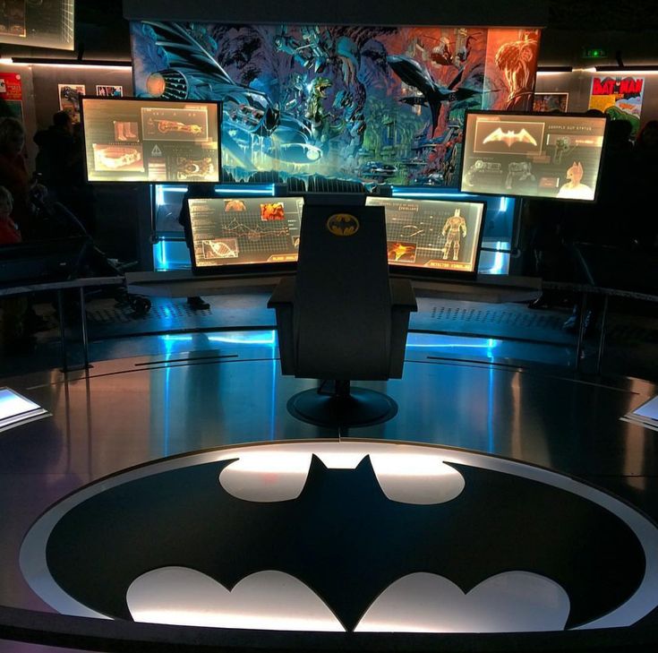 a batman themed desk with multiple monitors in the background