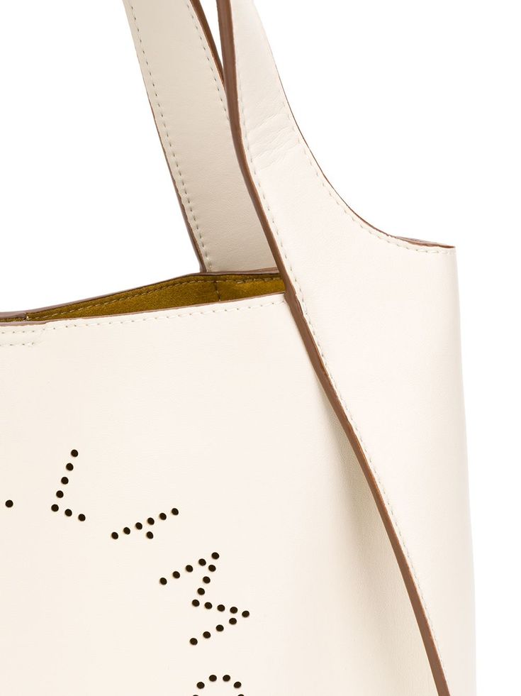 Best friends come in all shapes and sizes - it just so happens that this one comes in the form of a Stella McCartney small logo tote. Crafted from white faux leather, this hero piece keeps it nice and simple, with a minimal design decorated only by the perforated logo to the front. A friend for life. Featuring top handles, a detachable shoulder strap, a magnetic fastening, a removable pouch and a perforated logo design to the front. POSITIVELY CONSCIOUS: We’ve joined forces with ethical agency G Designer White Leather Bucket Bag, Luxury White Bucket Bag With Top Handle, Luxury White Bucket Bag With Top Carry Handle, Designer White Bucket Bag With Top Carry Handle, Beige Logo Tote Shoulder Bag, White Leather Shoulder Bag With Logo, White Shoulder Bag With Logo And Double Handle, Designer White Bucket Bag, Designer White Bucket Bag For Everyday Use