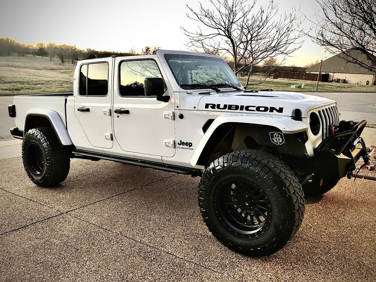 a white jeep is parked on the street