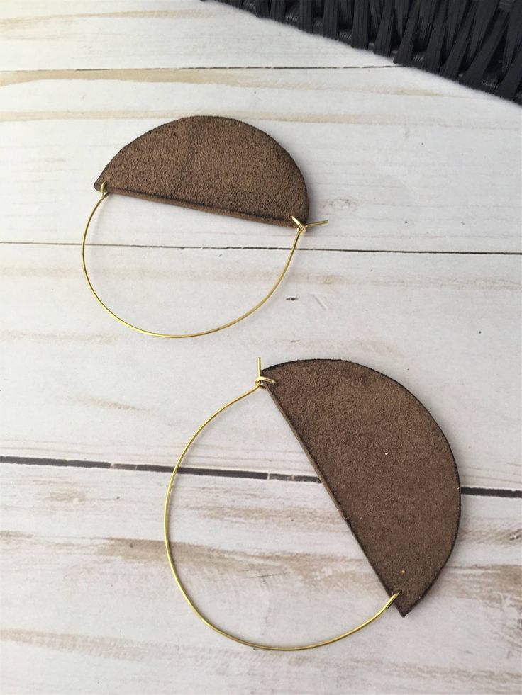 A lot of love and attention to detail went into these brown circle leather statement earrings. Leather pieces were cut into the half moon shape. Each moon was then given a tiny touch of gold paint on the bottom. The edges of the crescents were then burned to give them a darkened, rustic appearance. The ear wires were cut to length and formed into the curved shape. The ear wires are made from jeweler's bronze. These earrings measure approximately 2 5/16 x 3 inches. Thanks for checking out my earr Brown Single Hoop Earring As Gift, Brown Small Hoop Earrings As Gift, Brown Hoop Earrings With Ear Wire, Modern Small Hoop Brown Earrings, Modern Brown Small Hoop Earrings, Handmade Brown Hoop Earrings For Everyday Wear, Adjustable Brown Hoop Earrings, Brown Small Hoop Earrings With Ear Wire, Everyday Handmade Brown Hoop Earrings