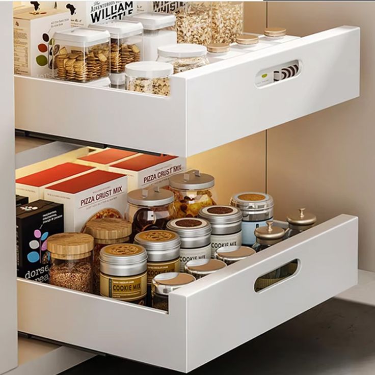 an open drawer in a kitchen filled with spices and other food items on the shelves